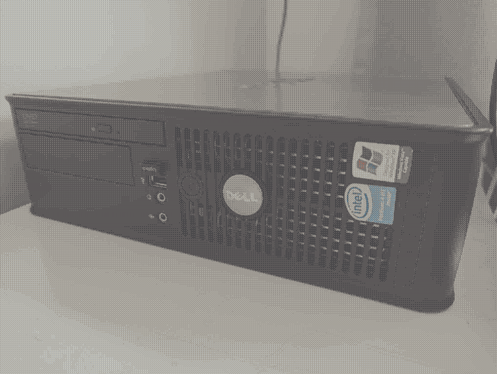 A dithered image of the Dell GX620 PC on a white worktop.